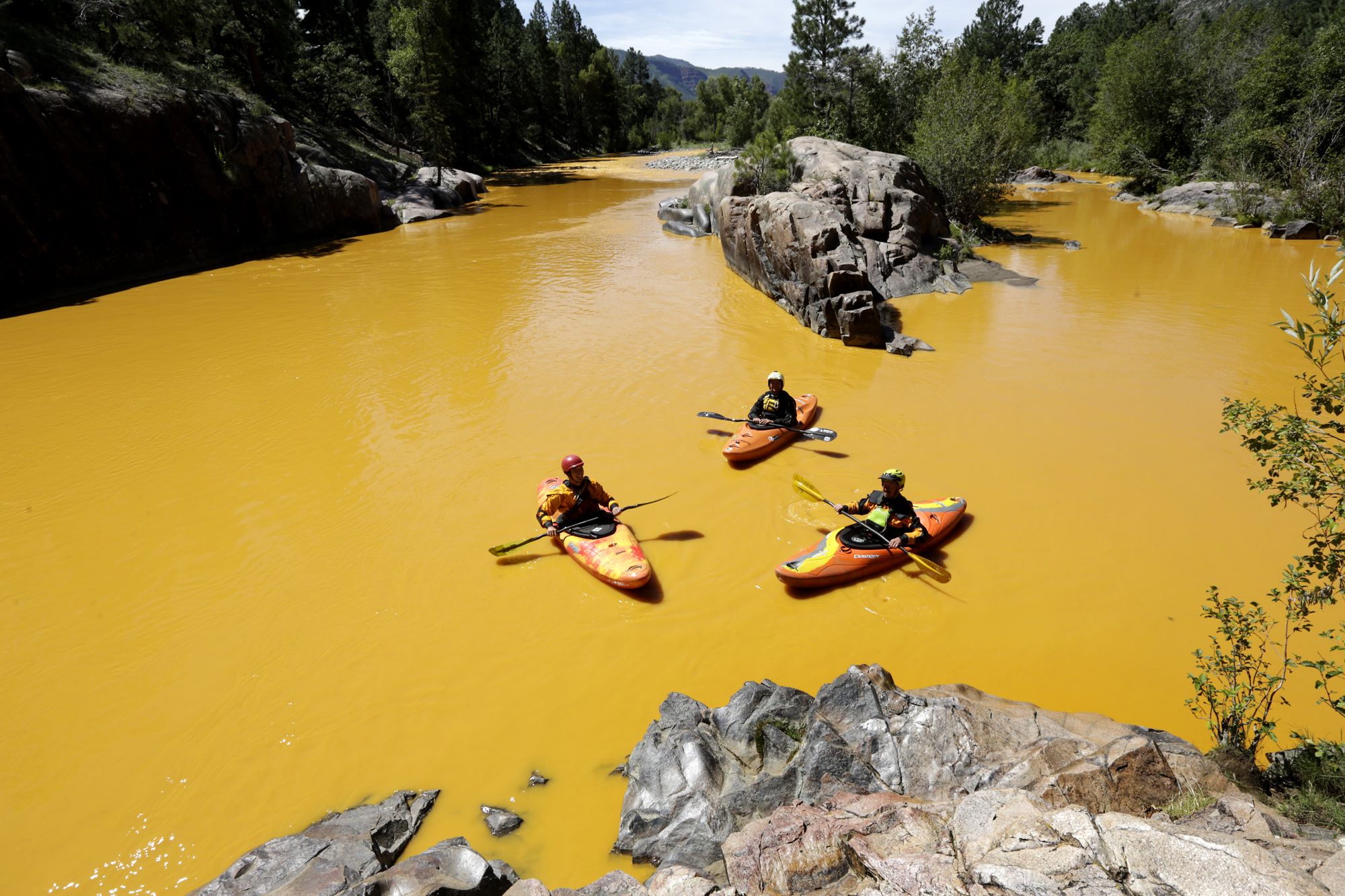 People kayak in the Animas River near Durango, Colo.