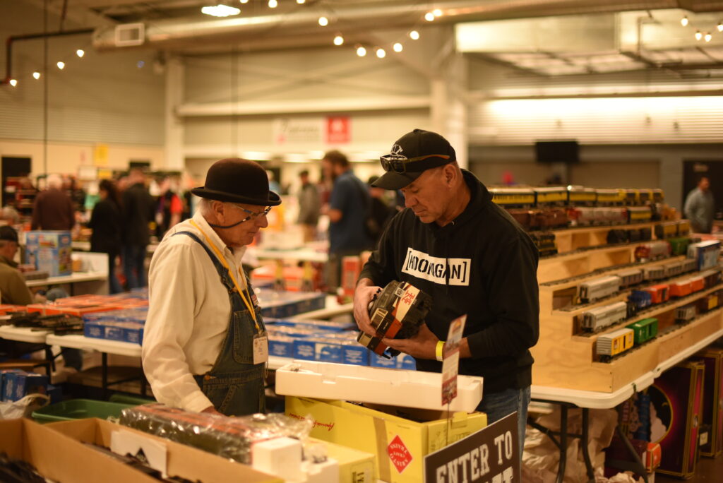 Two men looking at a model train