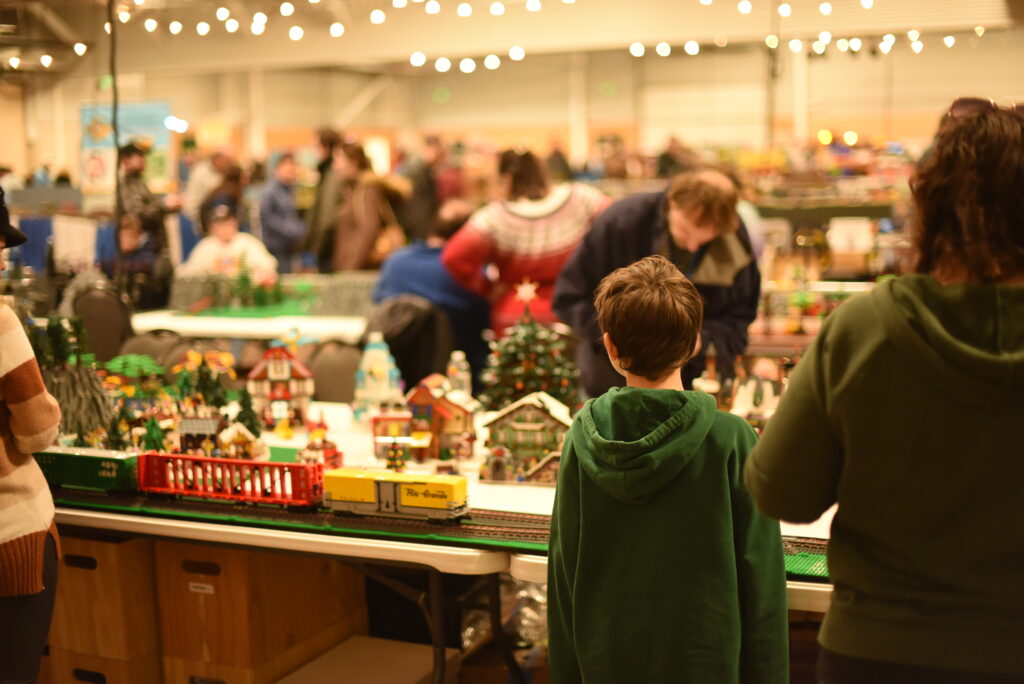 A boy looks at a LEGO model train