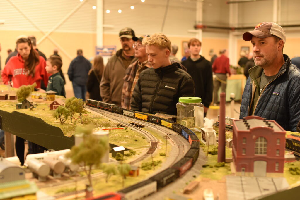 People look at a model train
