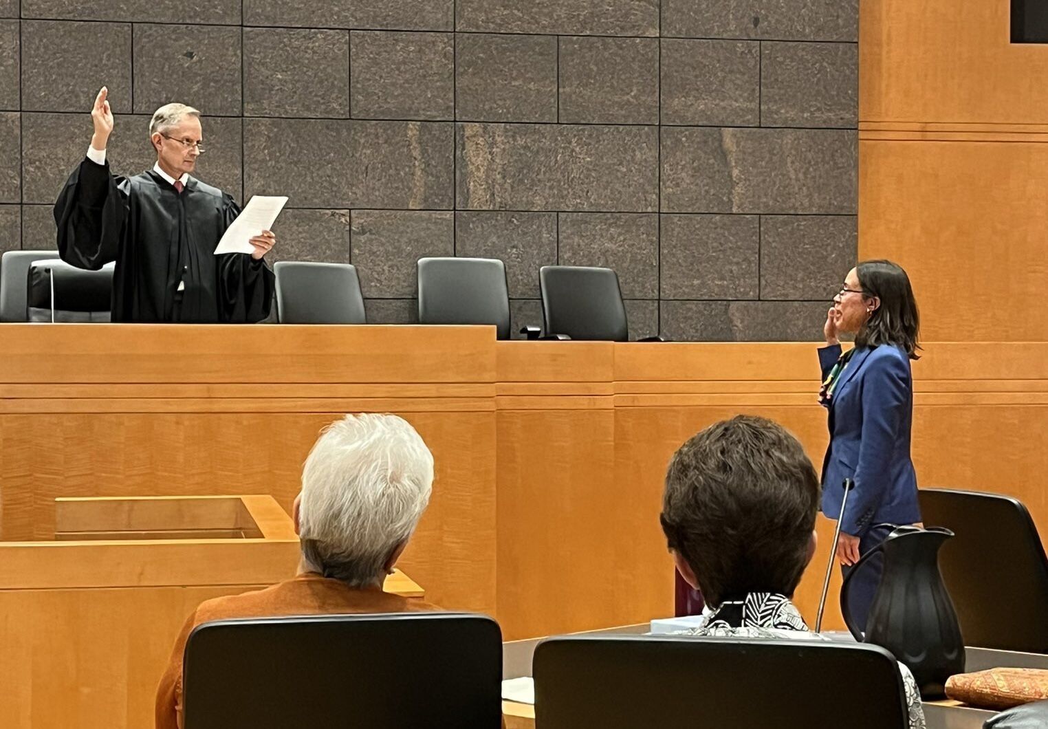 U.S. District Court Chief Judge Philip A. Brimmer swears in U.S. Magistrate Judge Kathryn A. Starnella during her investiture on Oct. 13, 2023. (Photo courtsey of Phil Weiser)