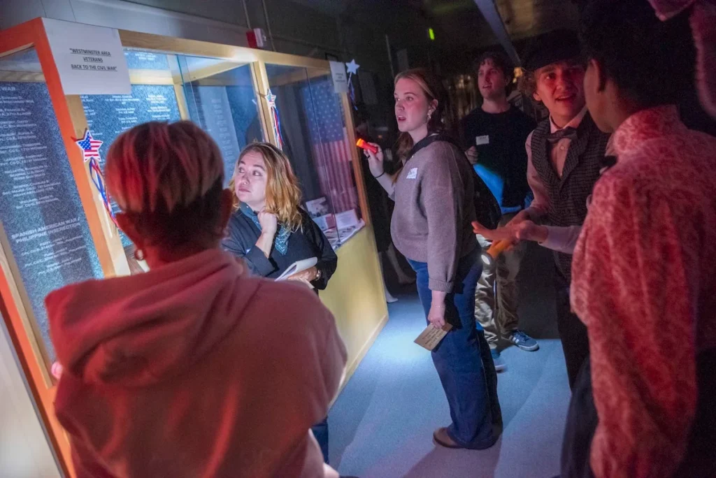 Audience members investigate a schoolhouse mystery at The Catamounts' 2025 production of 'A Town Called Harris.' (Michael Ensminger)