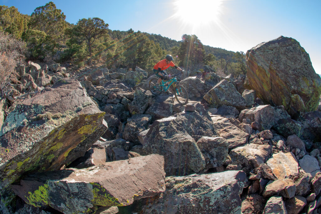 Joey Klein rides a spine or rock on a trail system he oversaw at Cedar City, Utah. Photo by Tyson Swasey