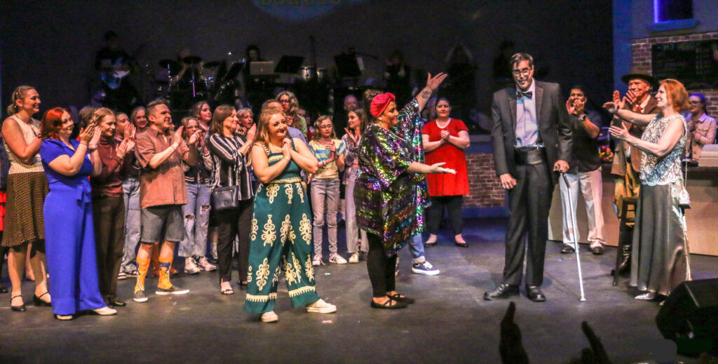 The cast of Magic Moments' annual show acknowledges the final performance by former University of Colorado football star Ed Reinhardt. Photo taken March 30, 2025, at Kent Denver School. (John Moore, Denver Gazette)