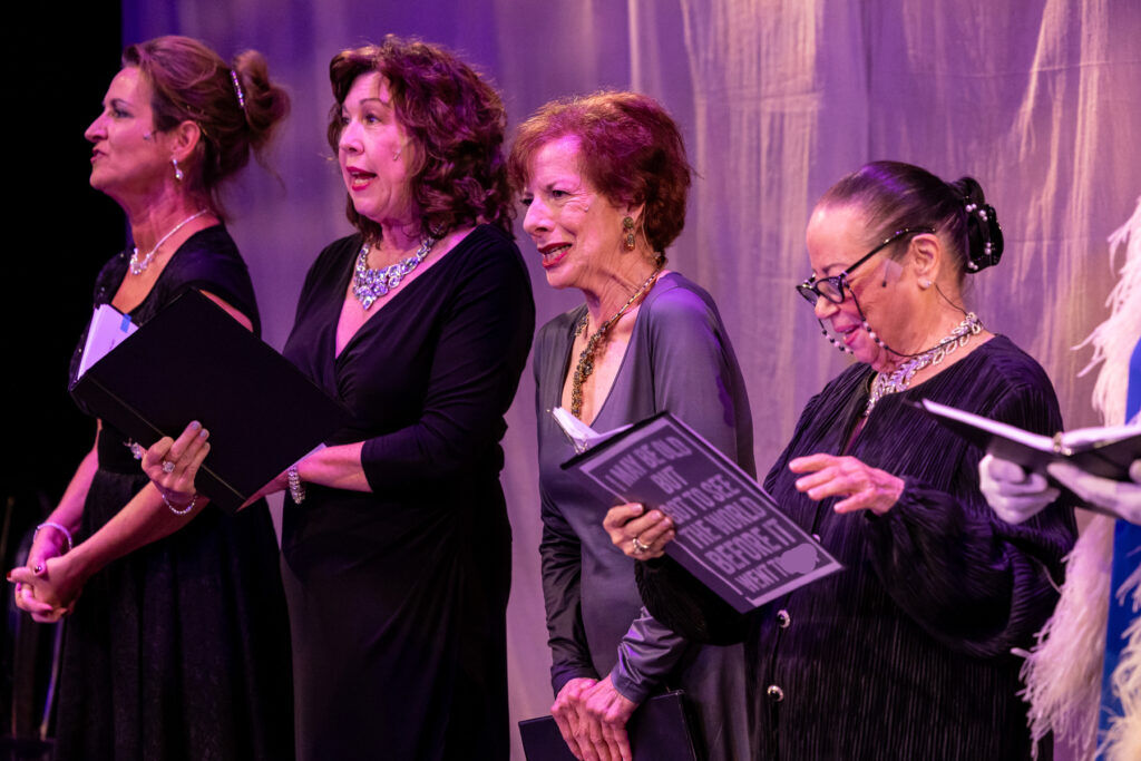 When Sue Leiser, right, finished her song, 'Broadway Baby,' in Vintage Theatre's 'Follies' in June 2025, she held up a message to the audience that ends with an expletive, which the Denver Gazette has digitally removed. The message: I may be old, but I got to see the world before it went to (bleep).’ (RDG Photography)