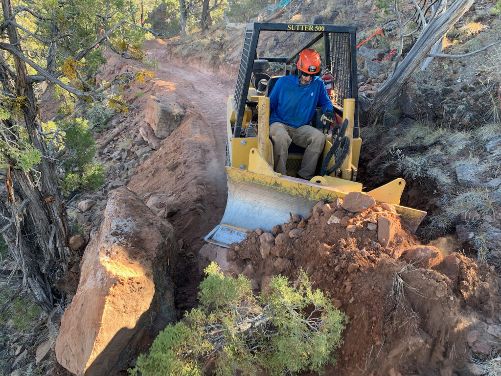 Joey Klein at the controls of a dozer on a machine-built trail in Utah. Photo courtesy Joey Klein