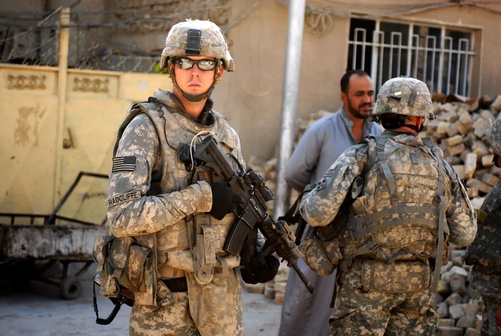 Staff Sgt. Matthew Radcliffe provides security for a member of the Striker Brigade command team during a patrol through the Adhamiyah District in northern Baghdad, Aug. 14, 2008. Radcliffe was a team leader with Headquarters and Headquarters Company, 3rd Special Troops Battalion, 3rd Brigade Combat Team, 4th Infantry Division, Multi-National Division – Baghdad. (Photo by Sgt. Zachary Mott)