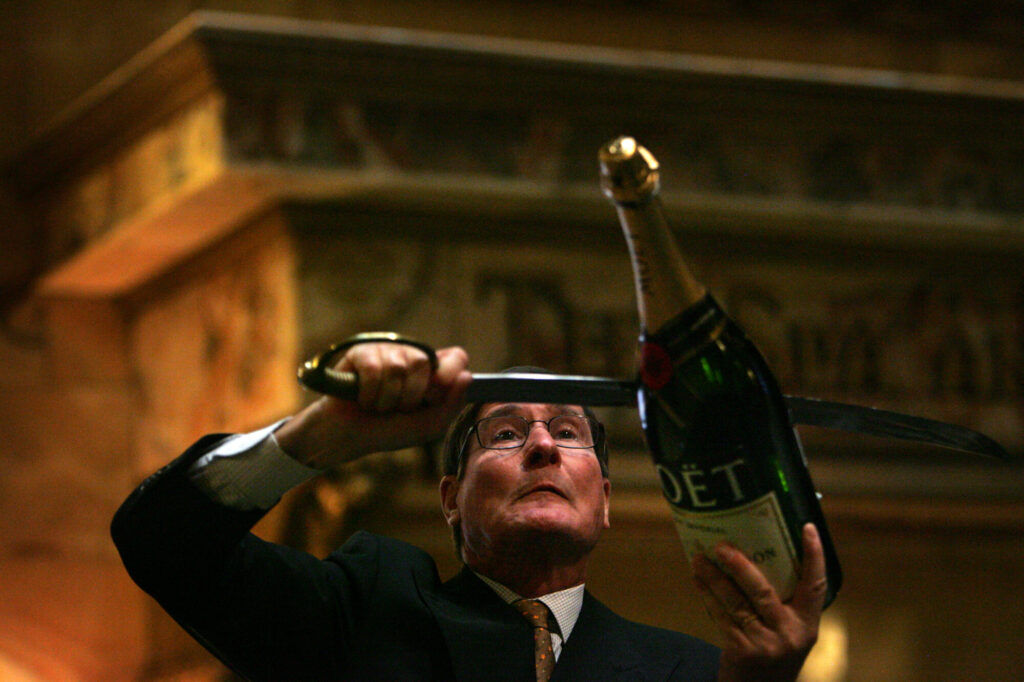 a man with a CHampagne saber