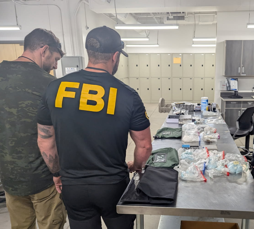 FBI field agents look over drugs obtained in a bust in Colorado Springs in 2025. (Courtesy Vikki Migoya, FBI Denver)