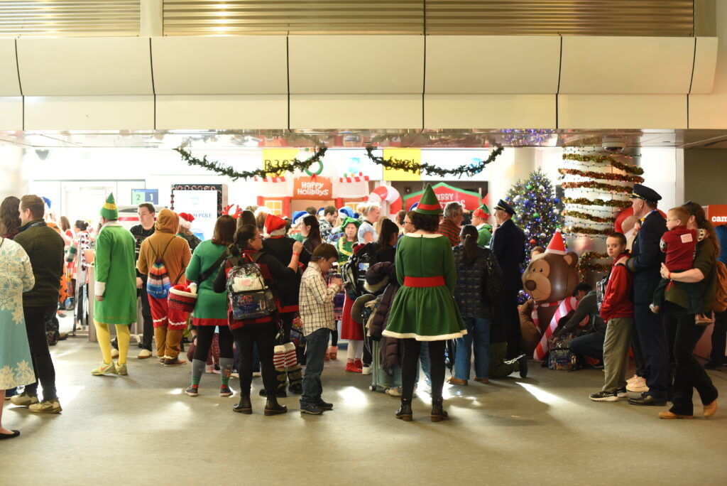 A group of people gather at an airplane terminal