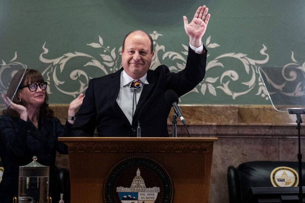 Gov. Jared Polis waves as he concludes his final State of the State address to the joint members of the Colorado General Assembly at the state Capitol on Thursday, Jan. 15, 2026 (Stephen Swofford, Denver Gazette)