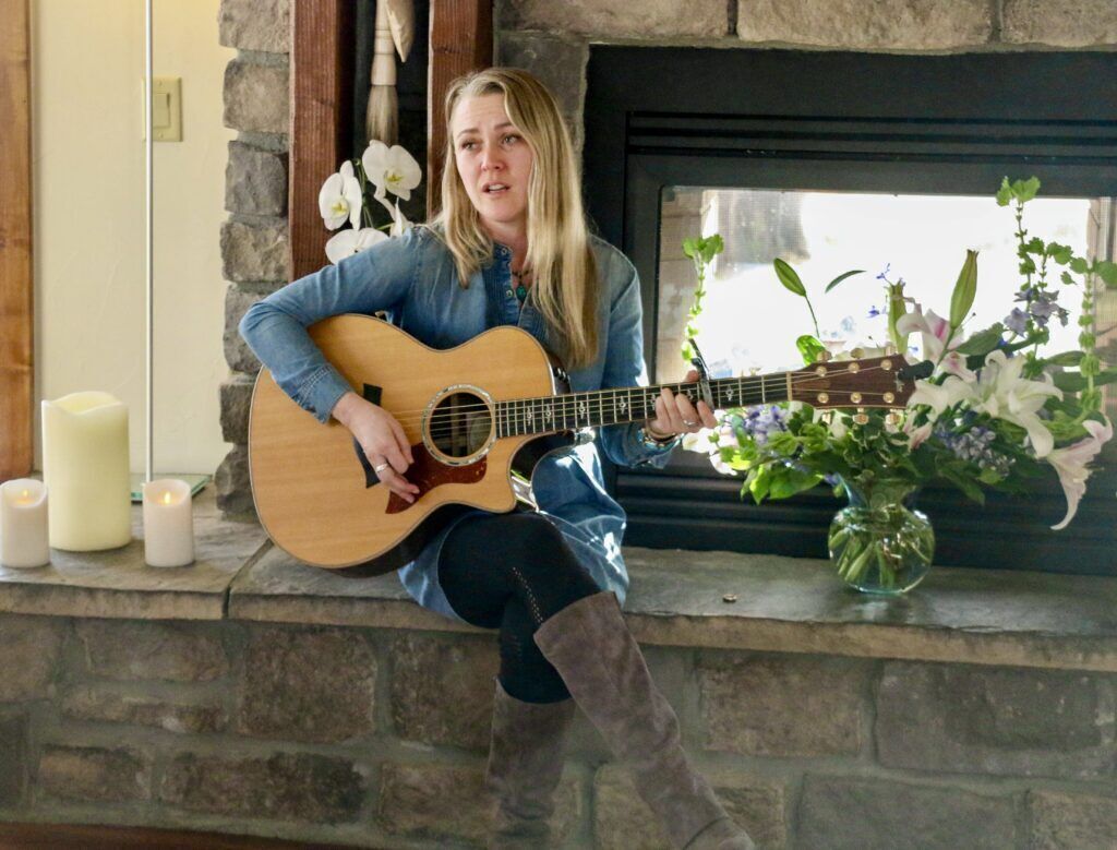Fort Collins folk singer Christine Alice sings at the wedding of her mother, Deb 'Bo' Dimon, to Wendy Ishii on Jan. 4. (John Moore, Denver Gazette)