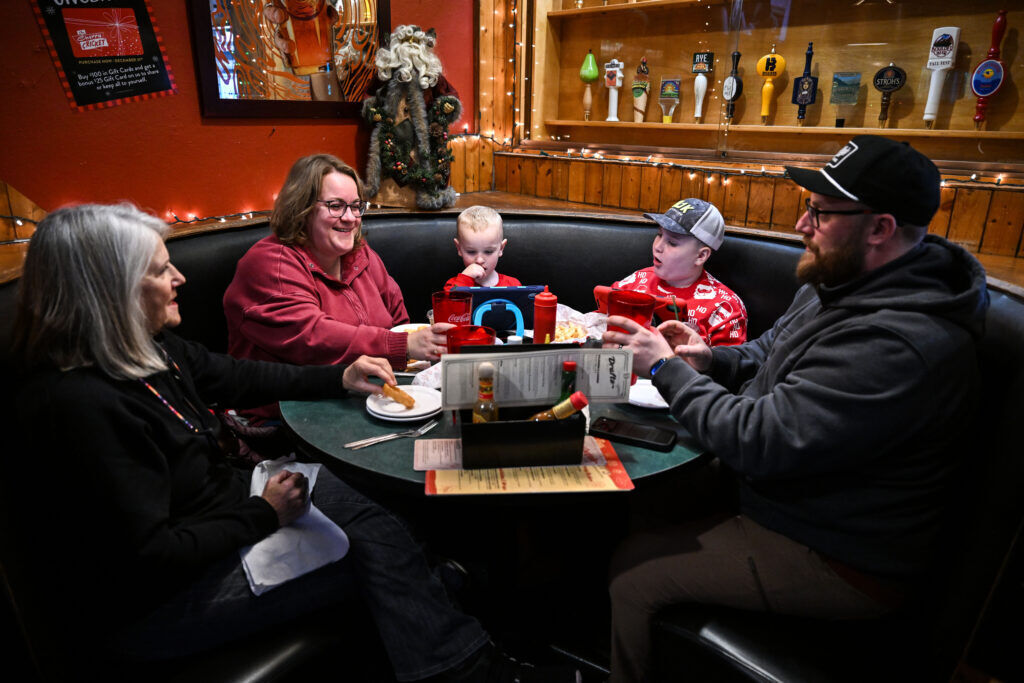 Connie Solowiej, left, takes her out-of-town family (from left) Kaylyn Schmohl, Thomas, 4, Brady, 10, and Andrew to lunch at the Cherry Cricket before a trip to the Denver Zoo on Friday, Dec. 12, 2025. The Schmohls are visiting from Delaware. (Stephen Swofford, Denver Gazette)