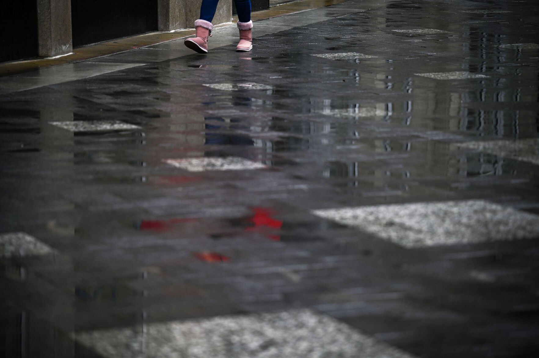 People walk over the diamond pavers on 16th Street Mall through a snow storm in Downtown Denver on Friday, April 18, 2025 (Stephen Swofford, Denver Gazette)