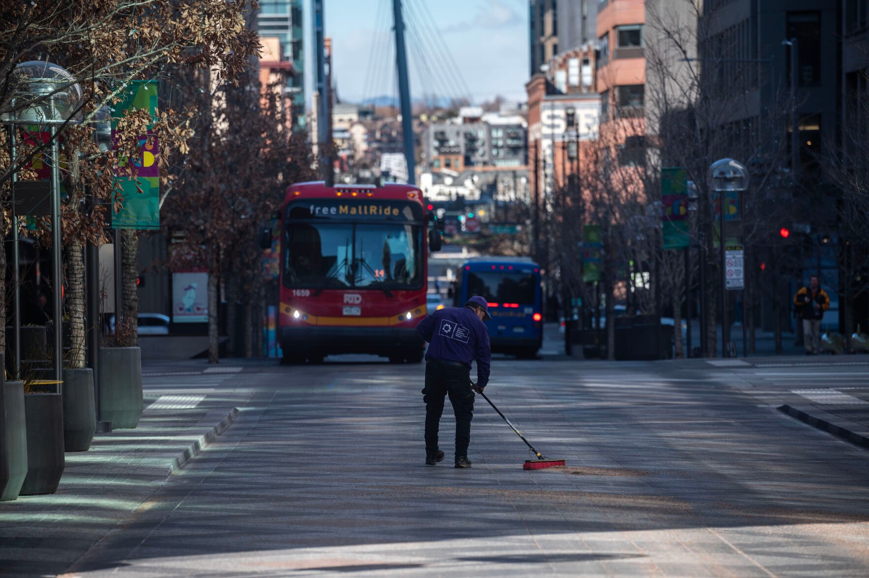 Workers sweep sand and salt from the street on the 16th street mall near Larimer on Monday, Jan. 13, 2025. Two people died and two others were injured in stabbings over the weekend. (Stephen Swofford, Denver Gazette) (Stephen Swofford/ Denver Gazette)