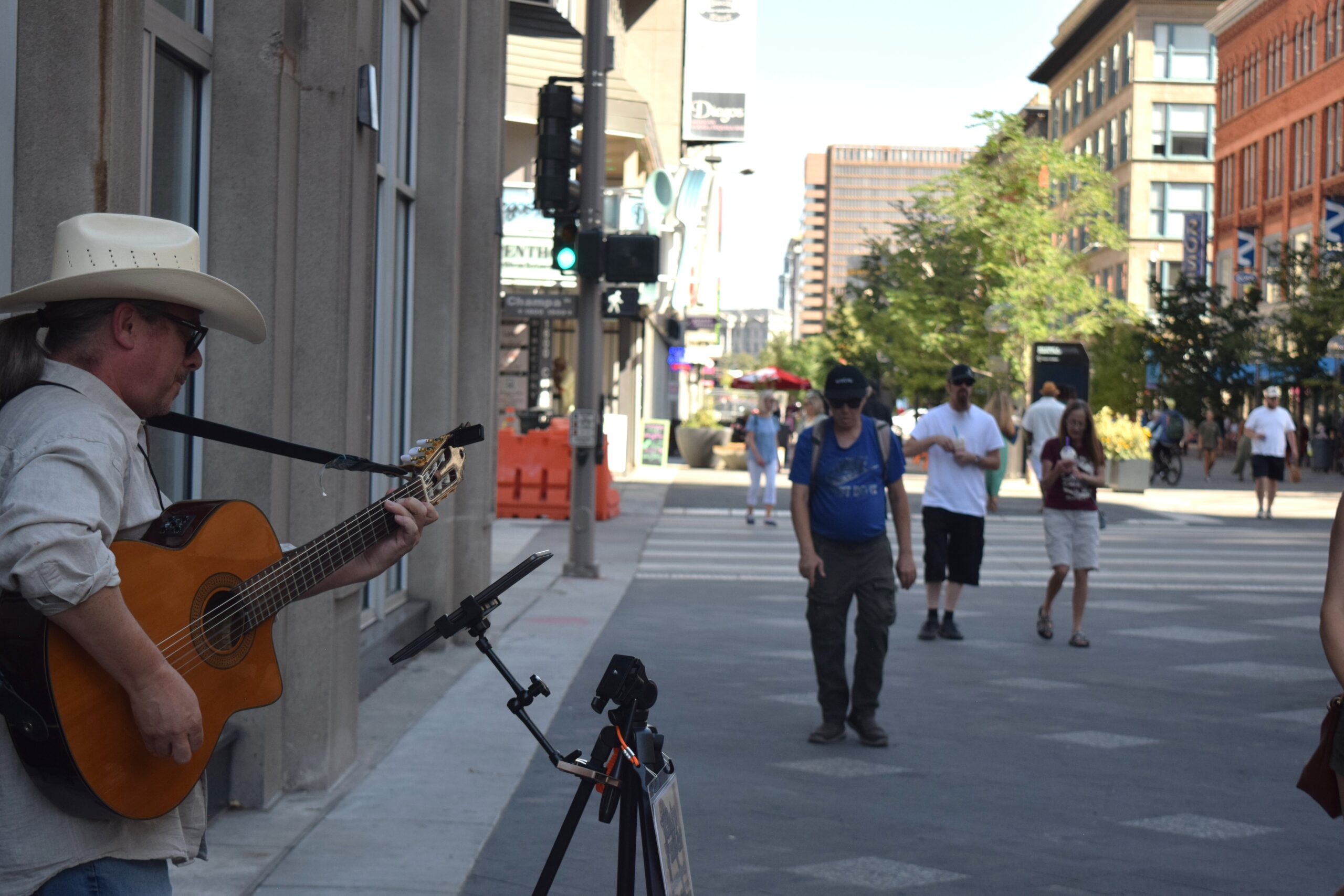 Chip Fuller, a western artist who plays originals and covers, busked on 16th Street on Aug. 3. Fuller questioned why he would practice in his bedroom when he can play on the street, making people happy. (Sage Kelley/Denver Gazette)