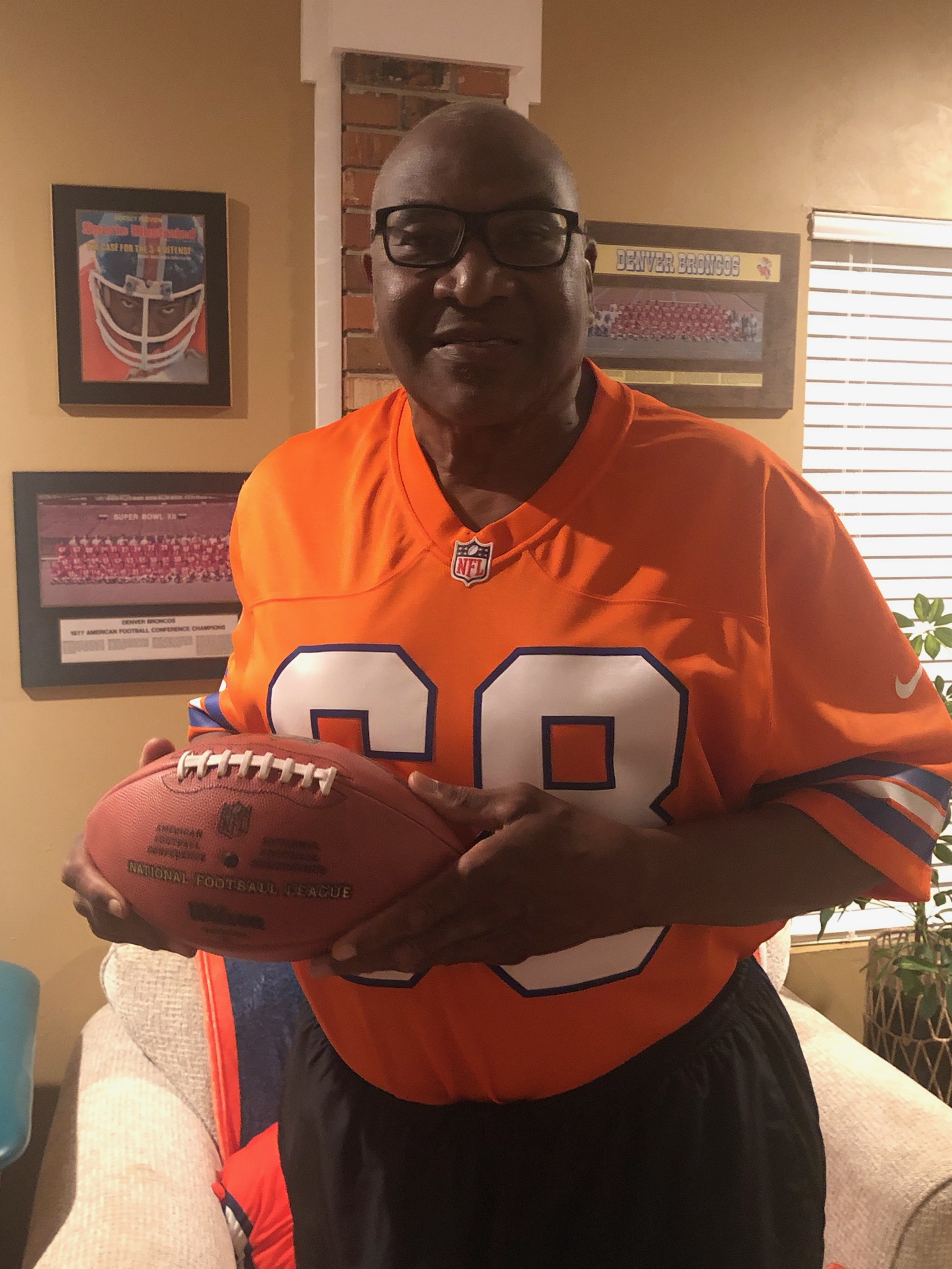Defensive lineman Rubin Carter, who played for the Denver Broncos from 1975-86, at his home in Tallahassee, Fla., on Dec. 19, 2024. He is holding the ball with which he scored his only NFL touchdown on a 2-yard fumble return on Nov. 11, 1979 against New England. Photo courtesy of Rubin Carter.