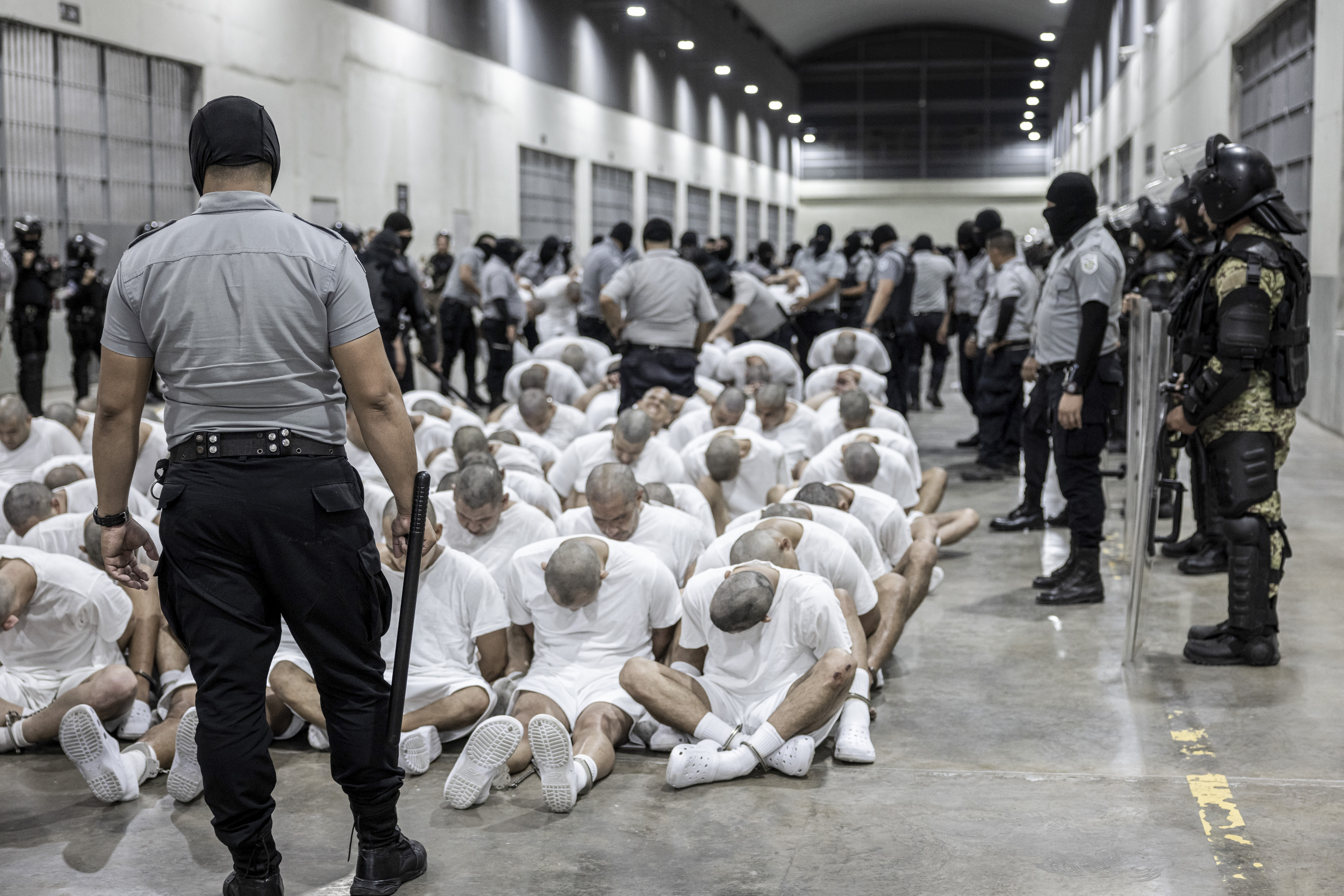 FILE - In this photo provided by El Salvador's presidential press office, a prison guard transfers deportees from the U.S., alleged to be Venezuelan gang members, to the Terrorism Confinement Center in Tecoluca, El Salvador, March 16, 2025. (El Salvador presidential press office via AP, File) (HOGP)