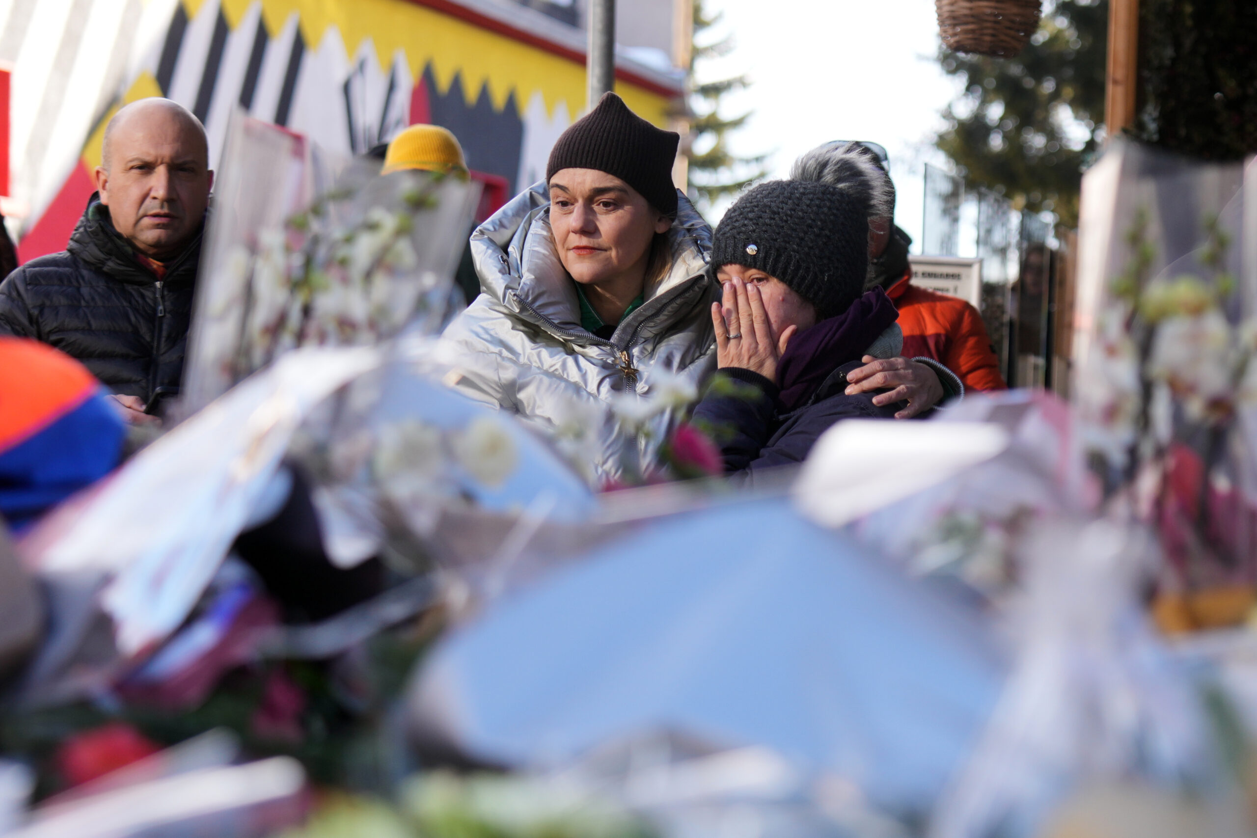 Swiss investigators believe sparkling candles atop wine bottles ignited fatal bar fire