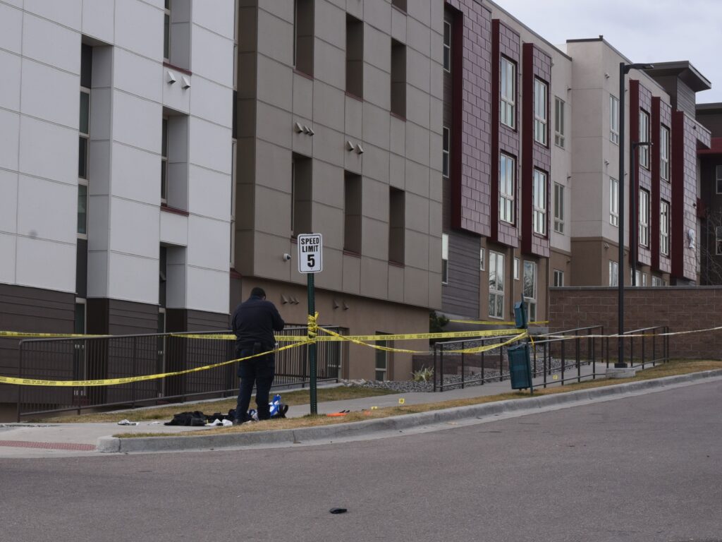 A crime scene photographer takes a photo of evidence
