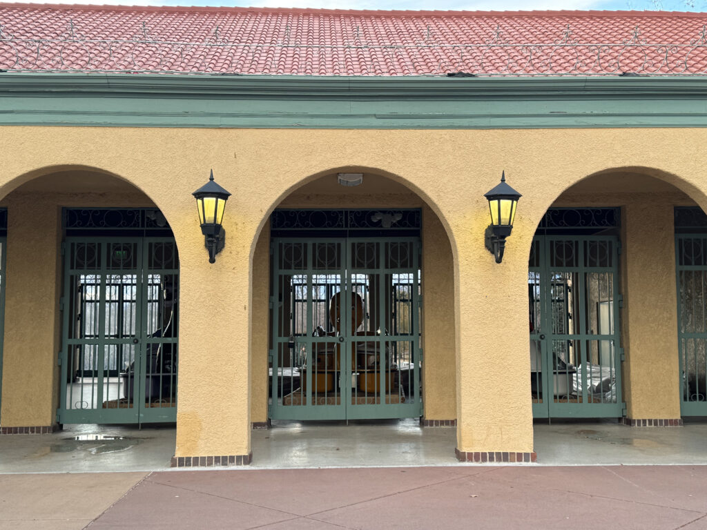 Three paddleboats sit locked behind gates