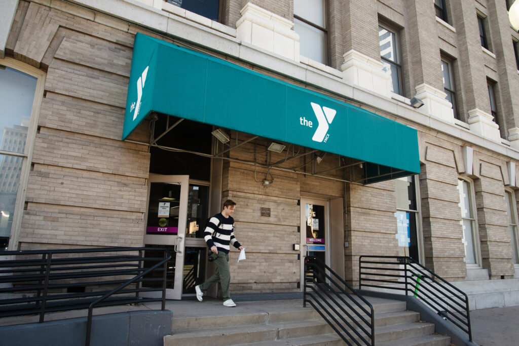 a brown building with a green awning
