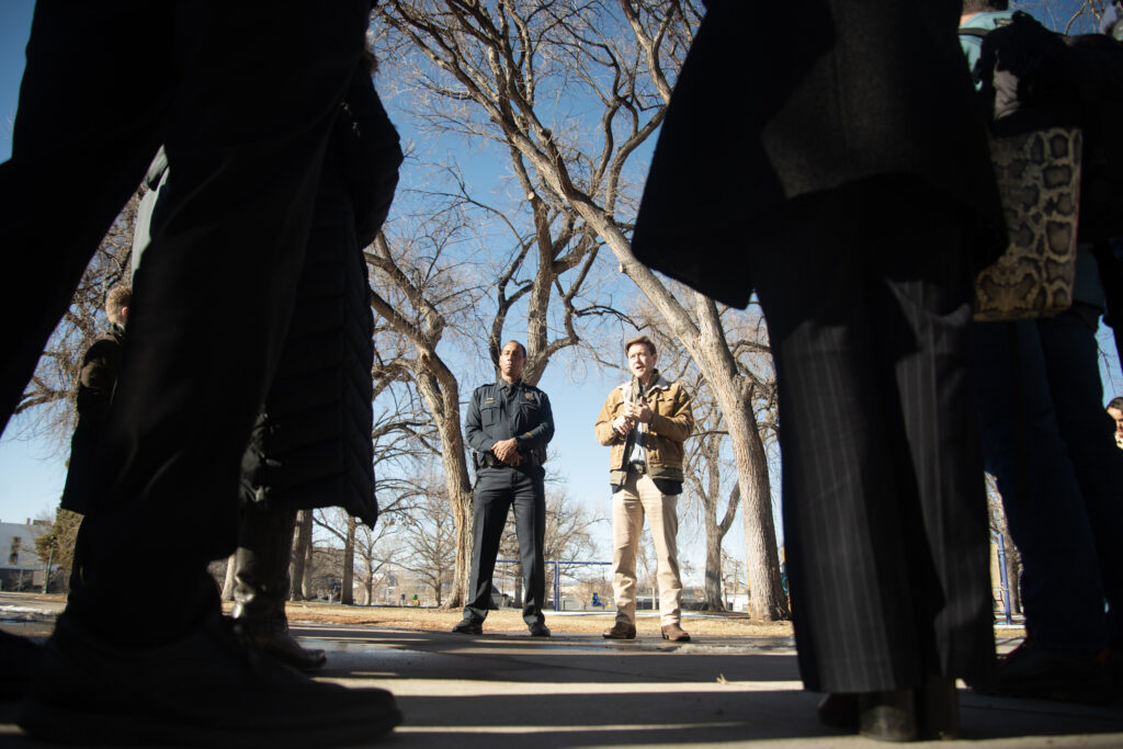 two men standing in a park