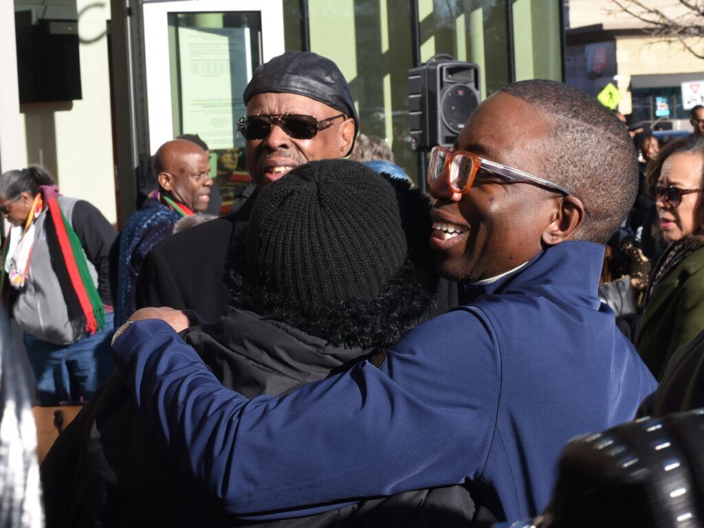 Two people hug each other in a crowd