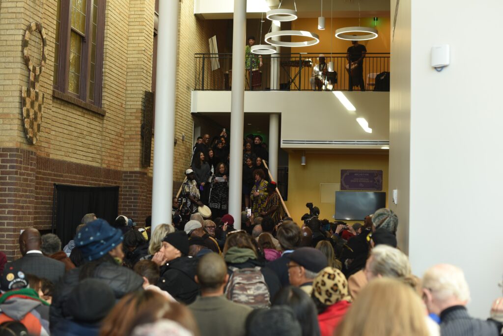 A crowd of people in the lobby of a building