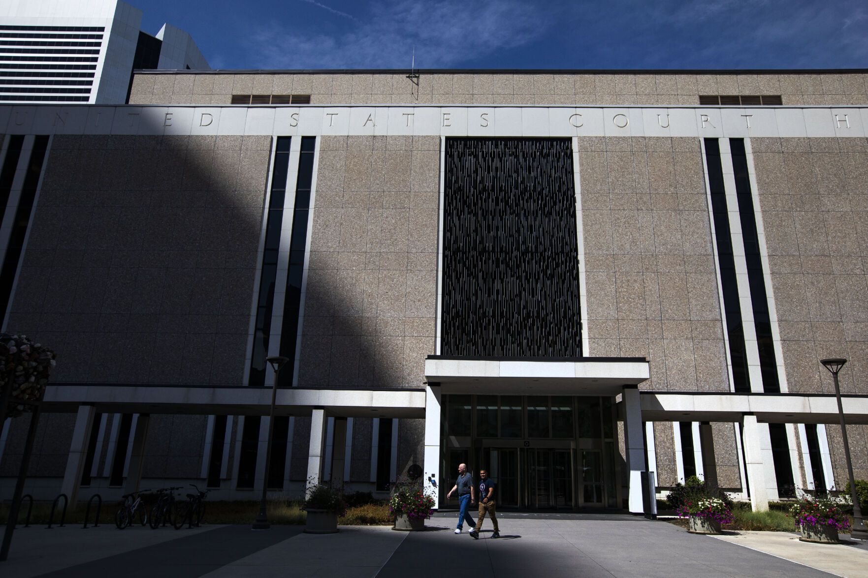 FILE PHOTO: Two men walk past an entrance to the Byron G. Rogers Federal Building and U.S. Courthouse in Denver.