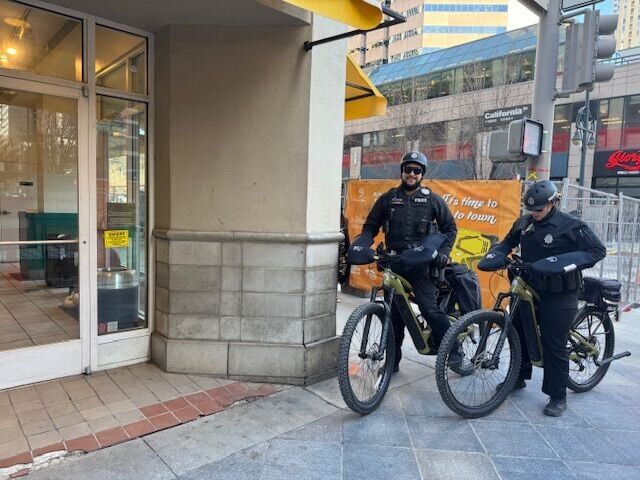 Denver Police Department officers James Harvey and Carrisa Rojas patrol 16th Street Mall at California Street on Tuesday following the stabbing death of an airline attendant Saturday night. (Carol McKinley, the Denver Gazette)