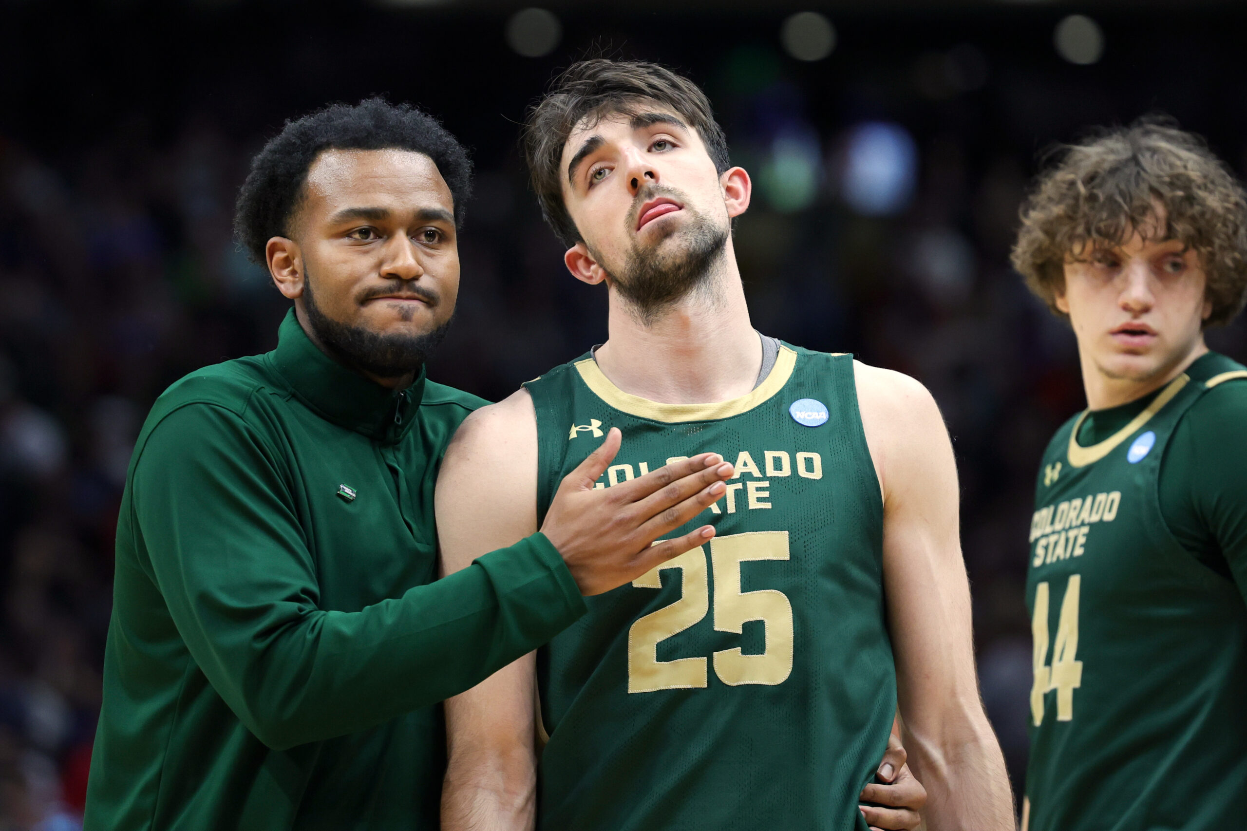 Colorado State guard Ethan Morton (25) is comforted by graduate assistant Anthony Holland after the team's loss to Maryland during the second half in the second round of the NCAA college basketball tournament, Sunday, March 23, 2025, in Seattle. (AP Photo/Ryan Sun) (Ryan Sun)