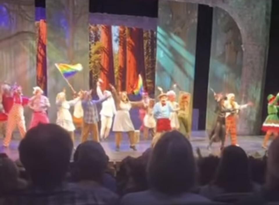 This audience photo capture shows the number 'Freak Flag' with cast waving Pride flags in 'Shrek,' presented by Parker Arts and Sasquatch Productions through Feb. 8. (Photo by Becky Toma)