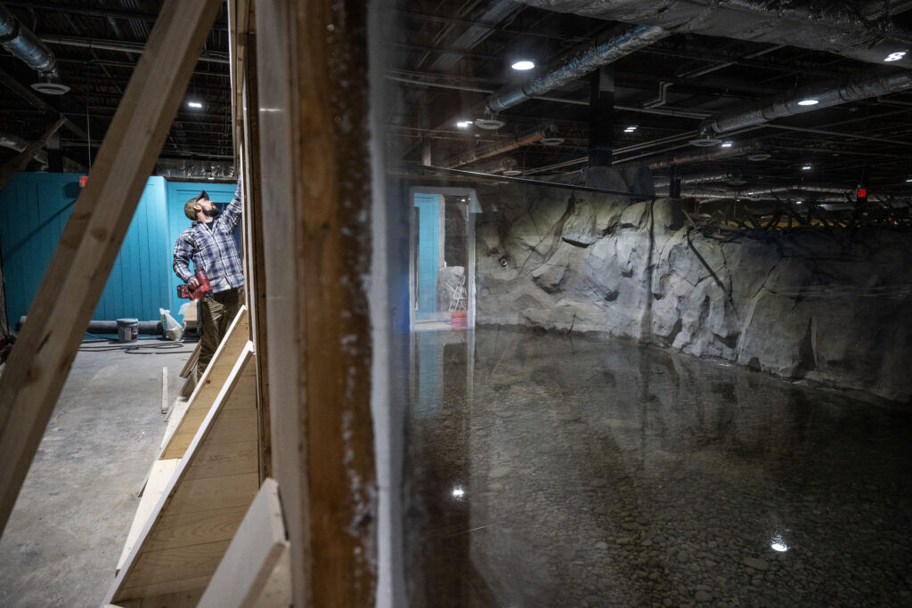 A construction worker puts on final touches at an aquarium in Colorado Springs. 