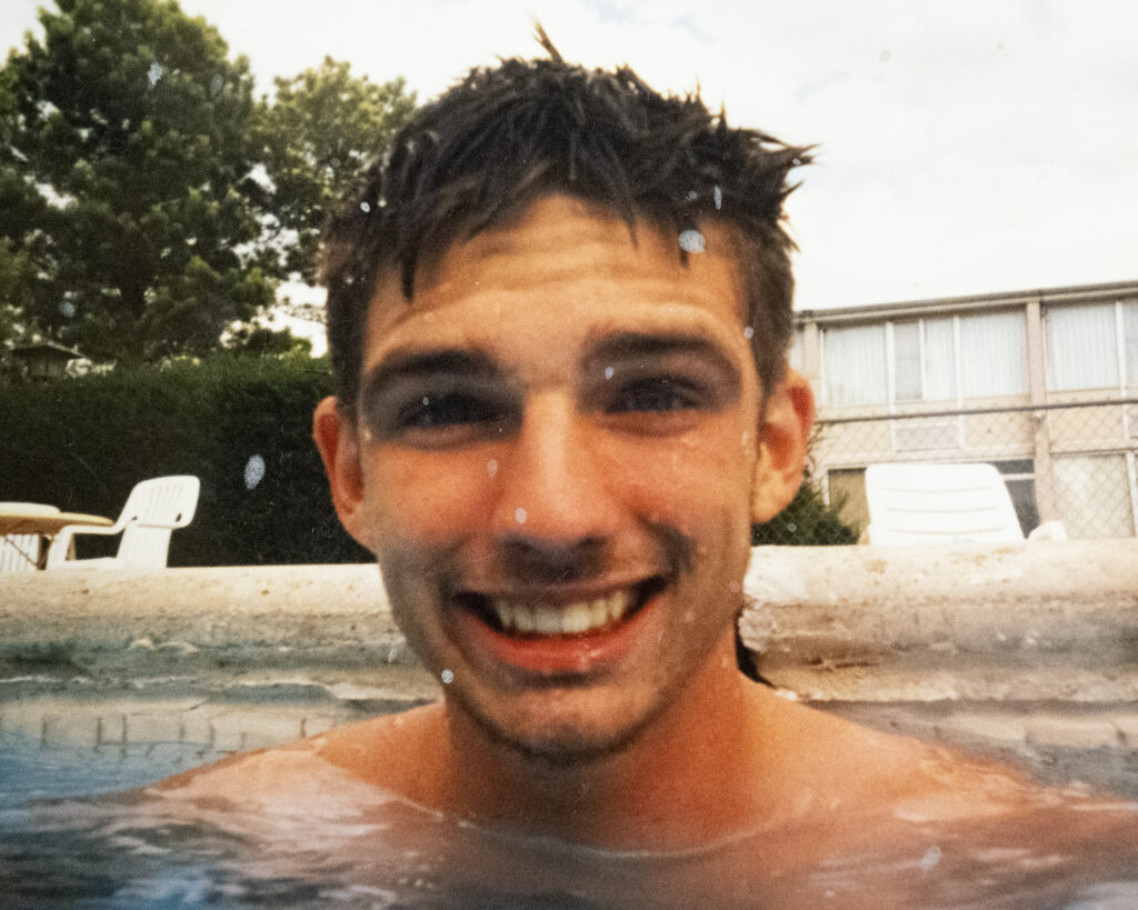 A man smiles in a pool 