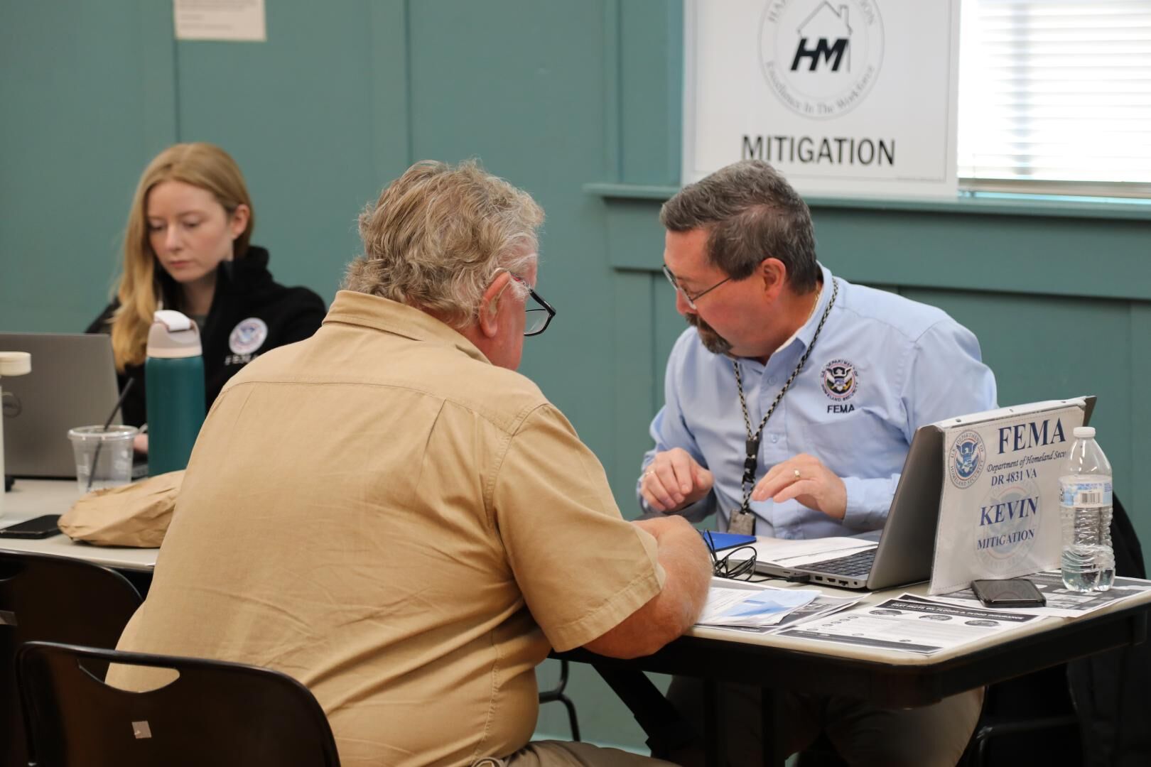 emergency management personnel sit at a table