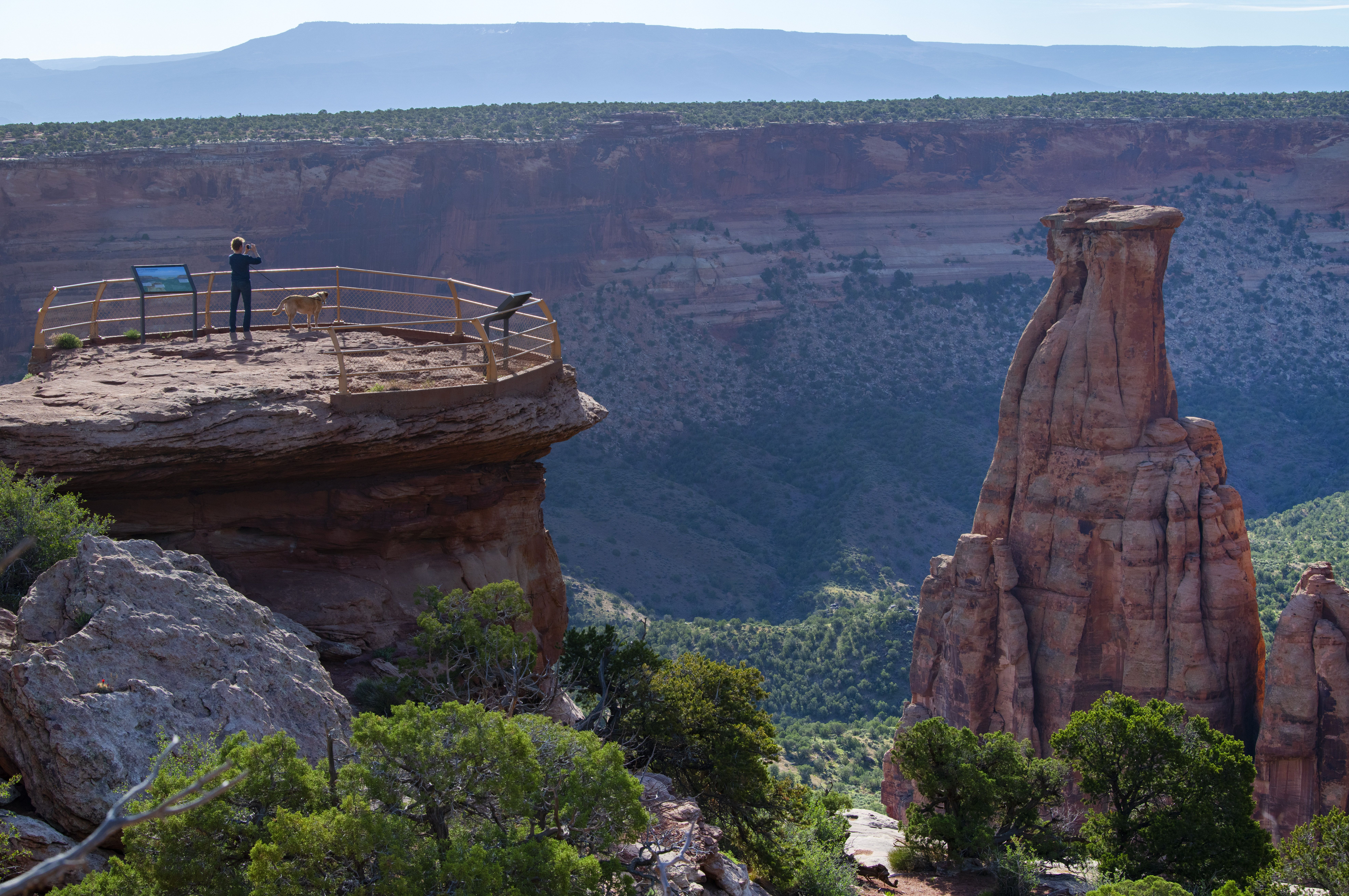 Cindy Engelman of Palmer Lake takes a picture of the valley floor in the morning light from the Grand View Overlook this week in the Colorado National Monument outside Fruita. Engelman and her husband, Dan Engelman, stopped in the monument on their way to the Blue Mesa Reservoir from Utah before heading home. Photo by Christian Murdock, The Gazette
