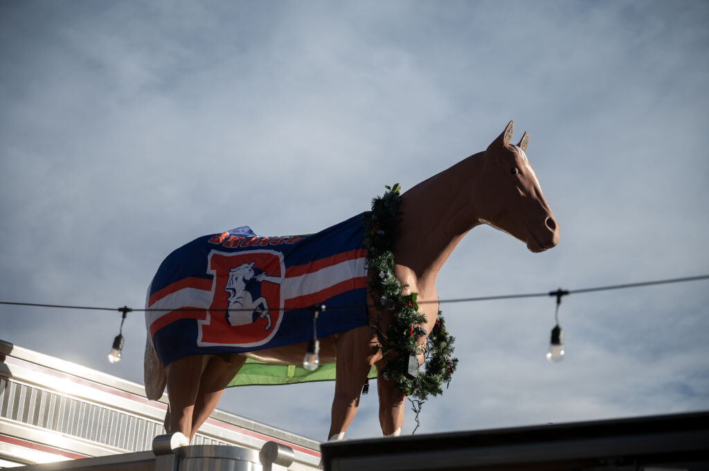 The horse on the roof of Davie’s Chuck Wagon Diner is dressed up in Broncos flags on Wednesday, Dec. 17, 2025. (Stephen Swofford, Denver Gazette)