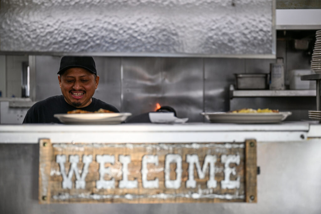 Cooks work on food in the back of Davie’s Chuck Wagon Diner on Wednesday, Dec. 17, 2025. (Stephen Swofford, Denver Gazette)