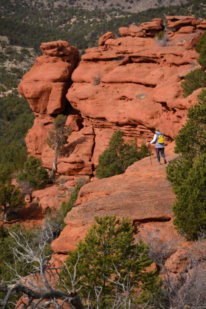 Tiffany Brewer of Canon City explores rock formations just off the Chipeta’s Way trail in Red Canyon Park outside Canon City, Colorado January 28, 2026. Photo by Mark Reis