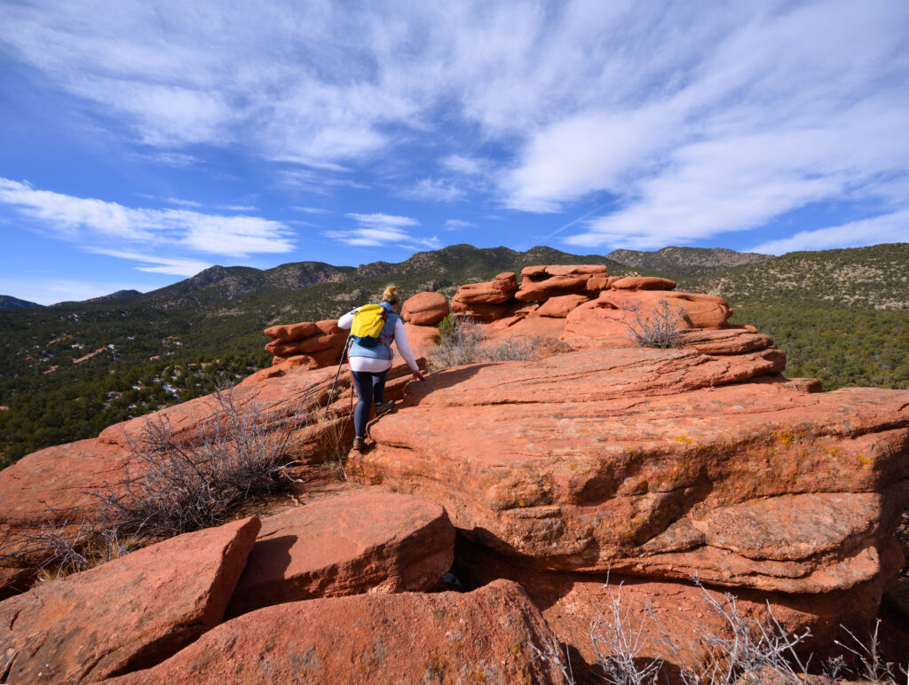 Tiffany Brewer of Canon City explores rock formations just off the Chipeta’s Way trail in Red Canyon Park outside Canon City, Colorado January 28, 2026. Photo by Mark Reis