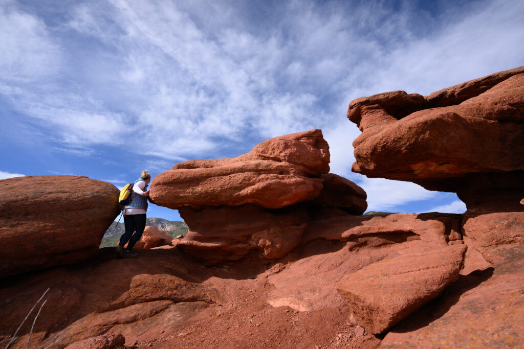 Tiffany Brewer of Canon City explores rock formations just off the Chipeta’s Way trail in Red Canyon Park outside Canon City, Colorado January 28, 2026. Photo by Mark Reis