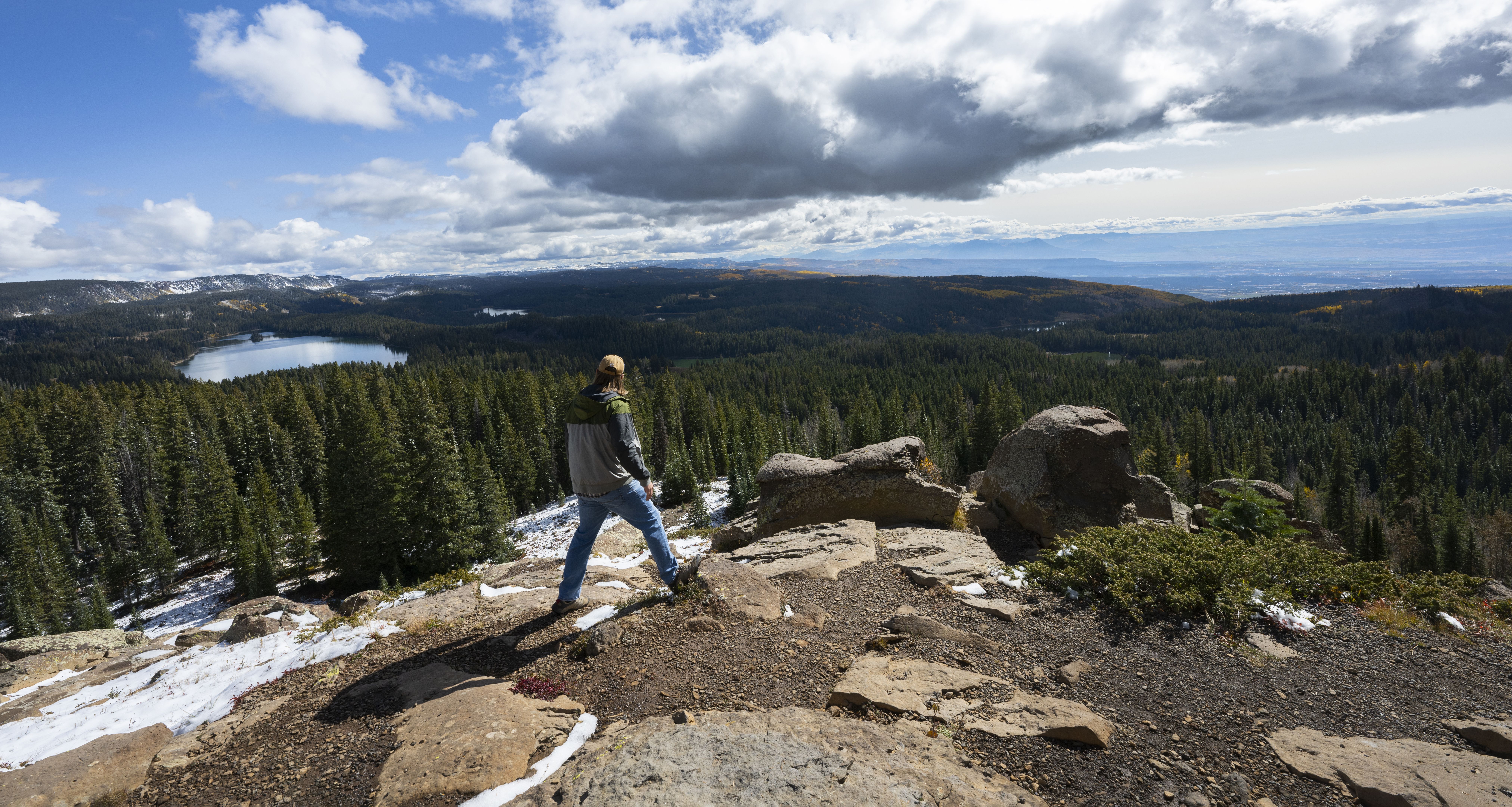 A hiker takes in the view of Island Lake from the Land of Lakes overview Wednesday, Oct. 4, 2023, on the Grand Mesa outside Grand Junction, Colo. The Land of Lakes trailhead is off Colorado 65, which runs through the national forest from Interstate 70 to Cedaredge, Colo. Photo by Christian Murdock, The Gazette