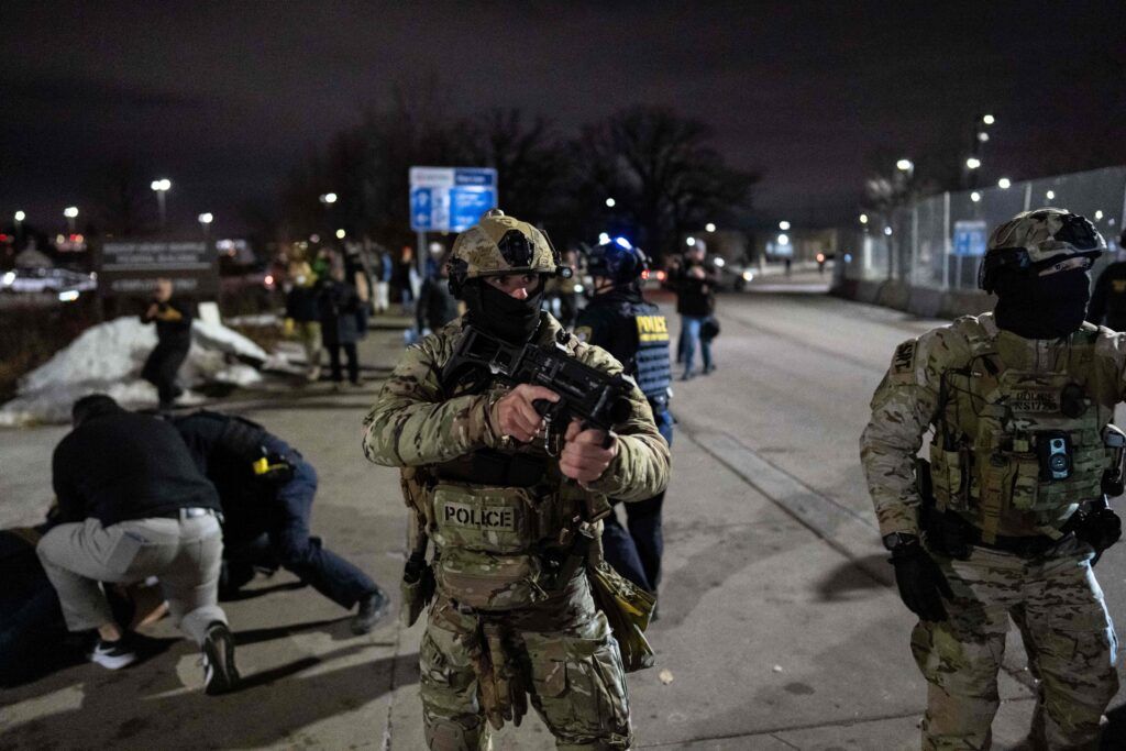 immigration agents holding weapons.