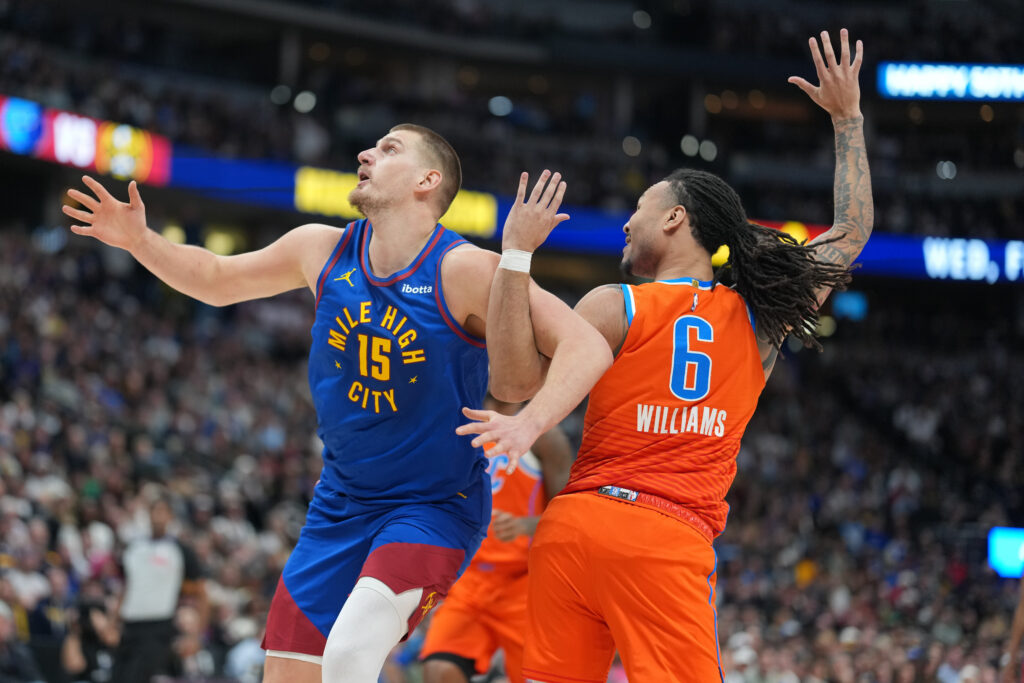 Denver Nuggets center Nikola Jokić, left, gets tangled up with Oklahoma City Thunder forward Jaylin Williams in the first half