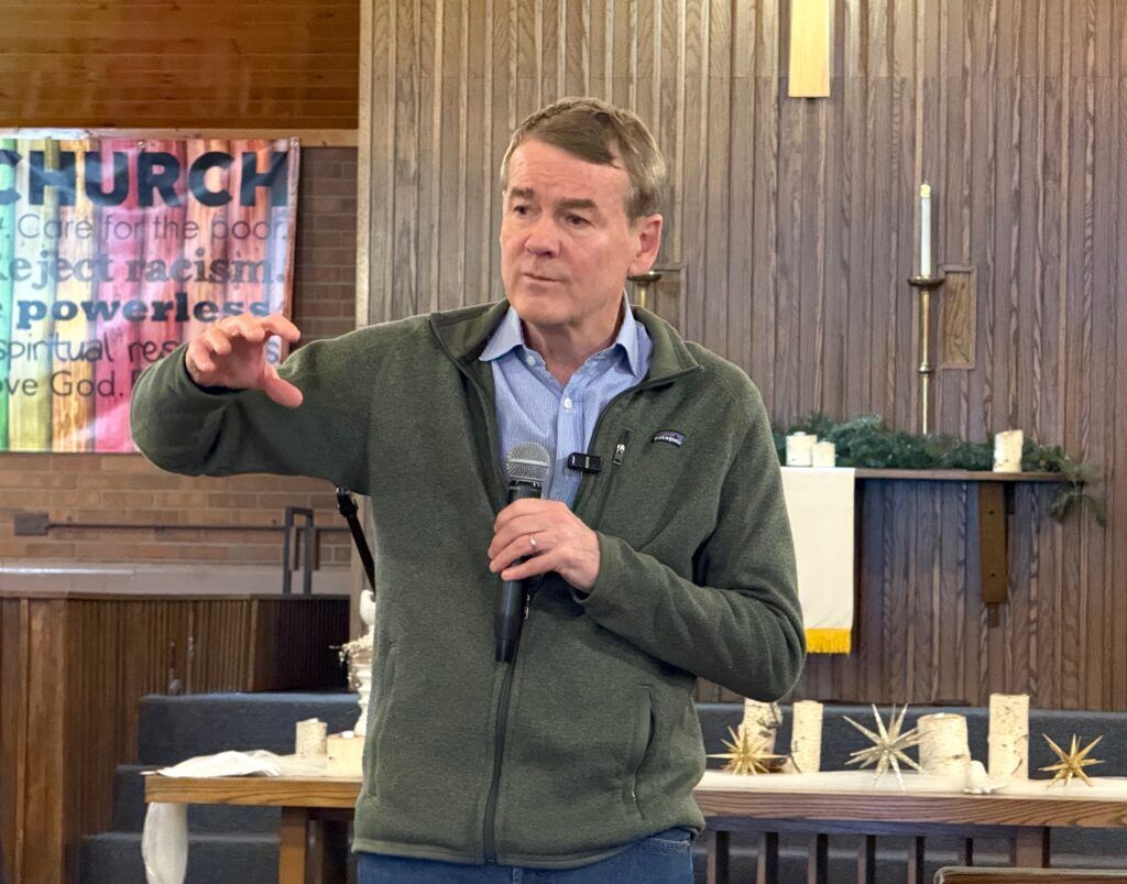 U.S. Sen. Michael Bennet, a Democratic gubernatorial candidate in Colorado, makes a point at a campaign town hall on Feb. 7, 2026, at Good Shepherd Presbyterian Church in Northglenn. (Ernest Luning/Colorado Politics)