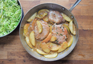 One-pot recipe brings together pork chops, apples and warm cabbage slaw