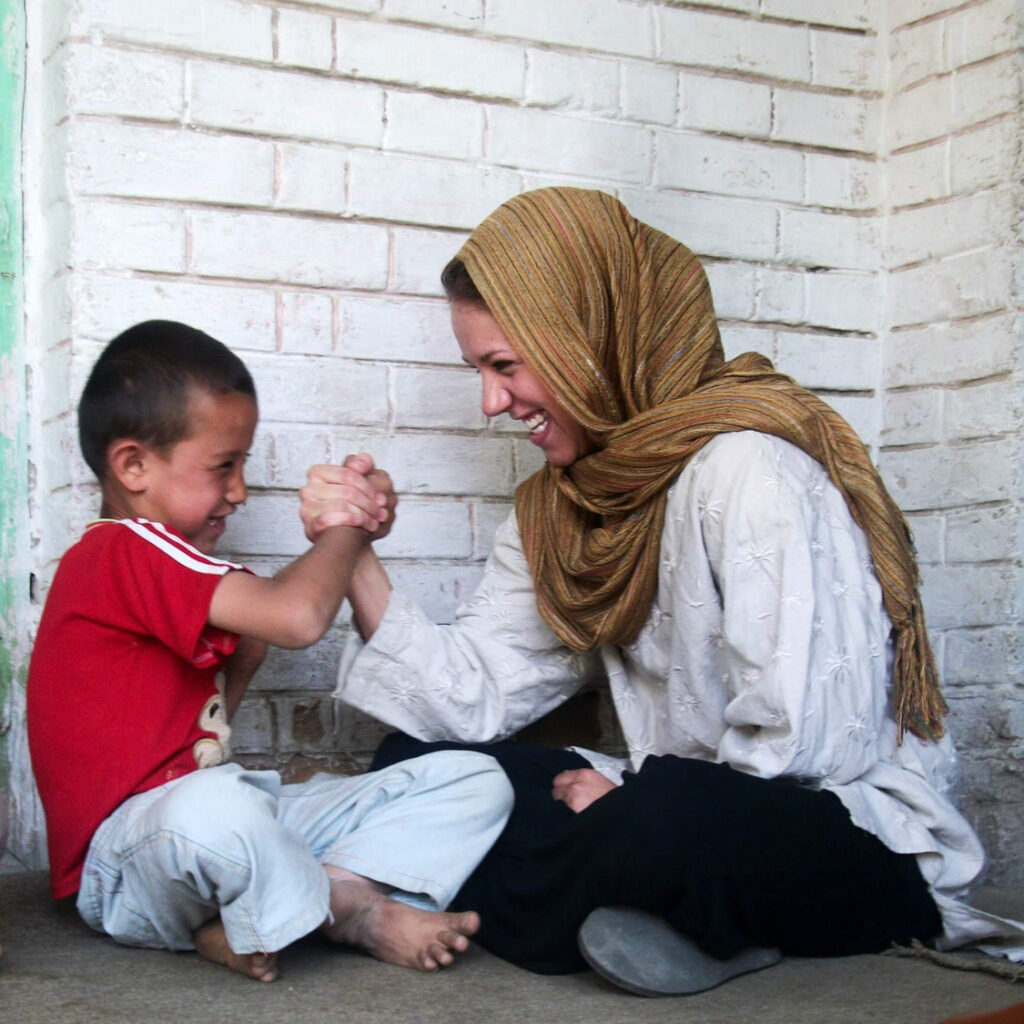 Janelle Orsborn is shown working with children as part of her mission to Afghanistan in this undated photo.(Provided by the Orsborn family)