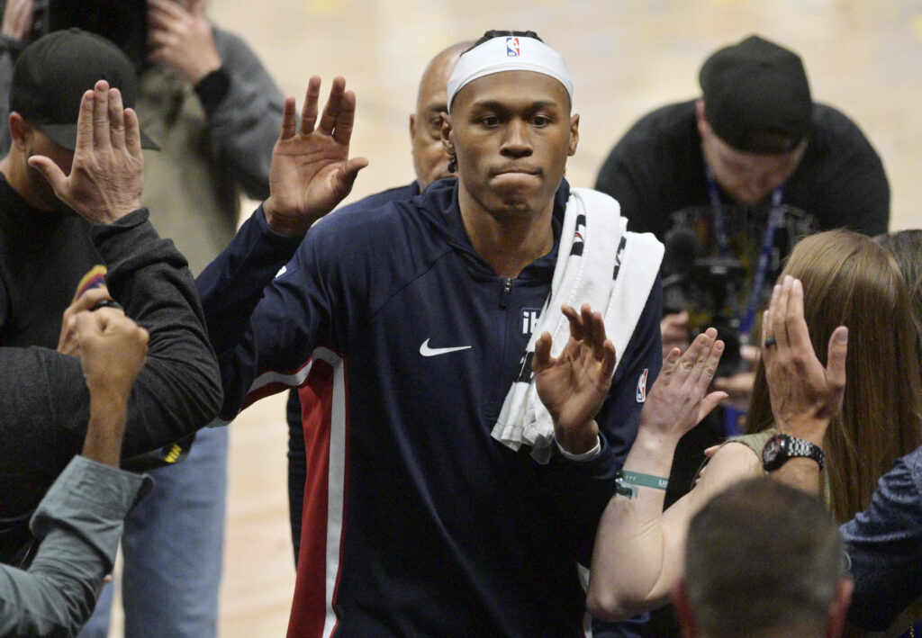 Nuggets’ Peyton Watson high-fives with fans after his first game since an injury in the beginning of February. They defeated the Trail Bazers at Ball Arena on Sunday. (The Gazette, Jerilee Bennett)