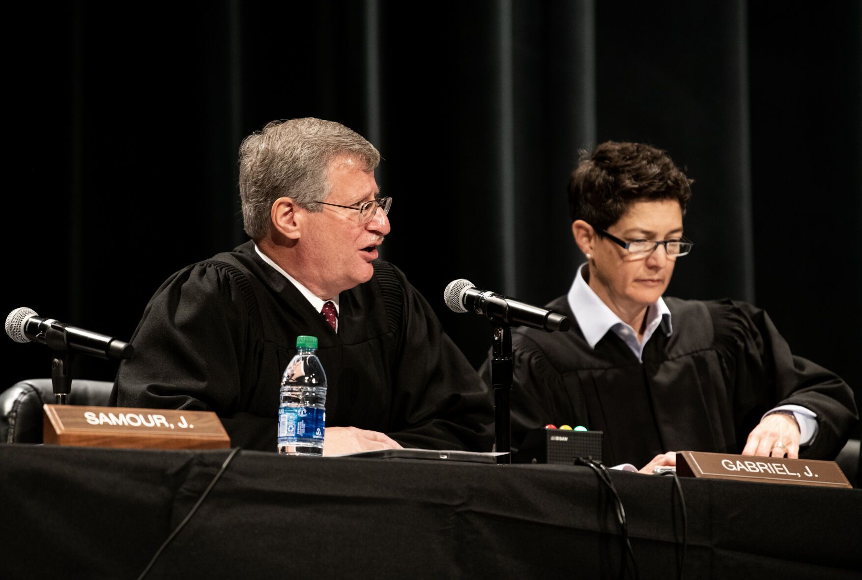 Colorado Supreme Court Justice Richard L. Gabriel, left, asks a question during a court session held at Pine Creek High School in Colorado Springs on Nov. 17, 2022.